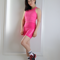 Cropped ribbed sports tank with built-in bra in pink and blue. Breathable, stretchy, and form-fitting for workouts or everyday wear.